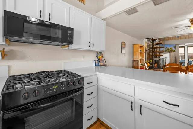 a kitchen with stainless steel appliances granite countertop a stove and a microwave