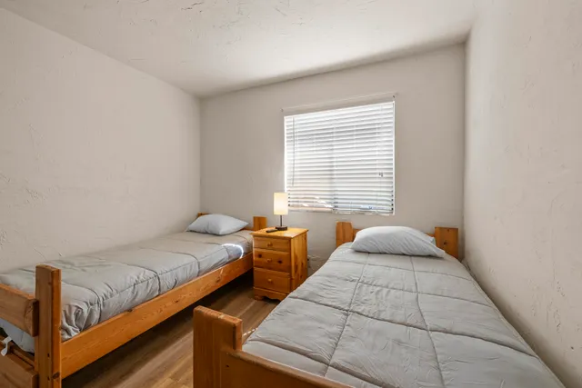 a bedroom with two beds and window