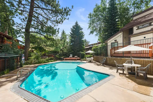 a view of a patio with chairs and a small yard