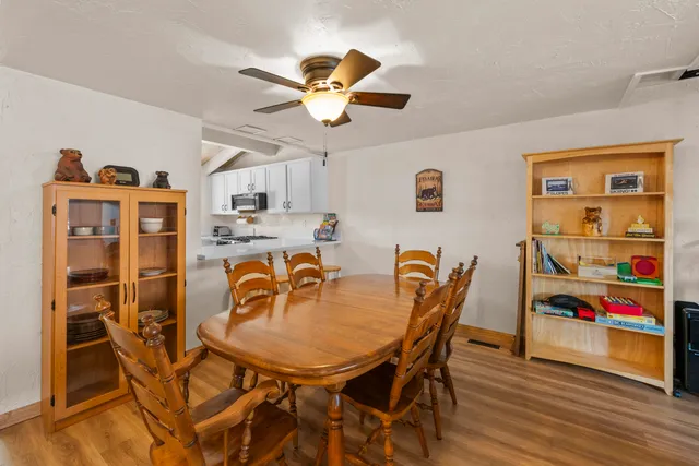 a view of a dining room with furniture and wooden floor