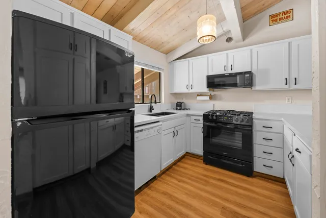 a kitchen with stainless steel appliances a stove microwave and cabinets