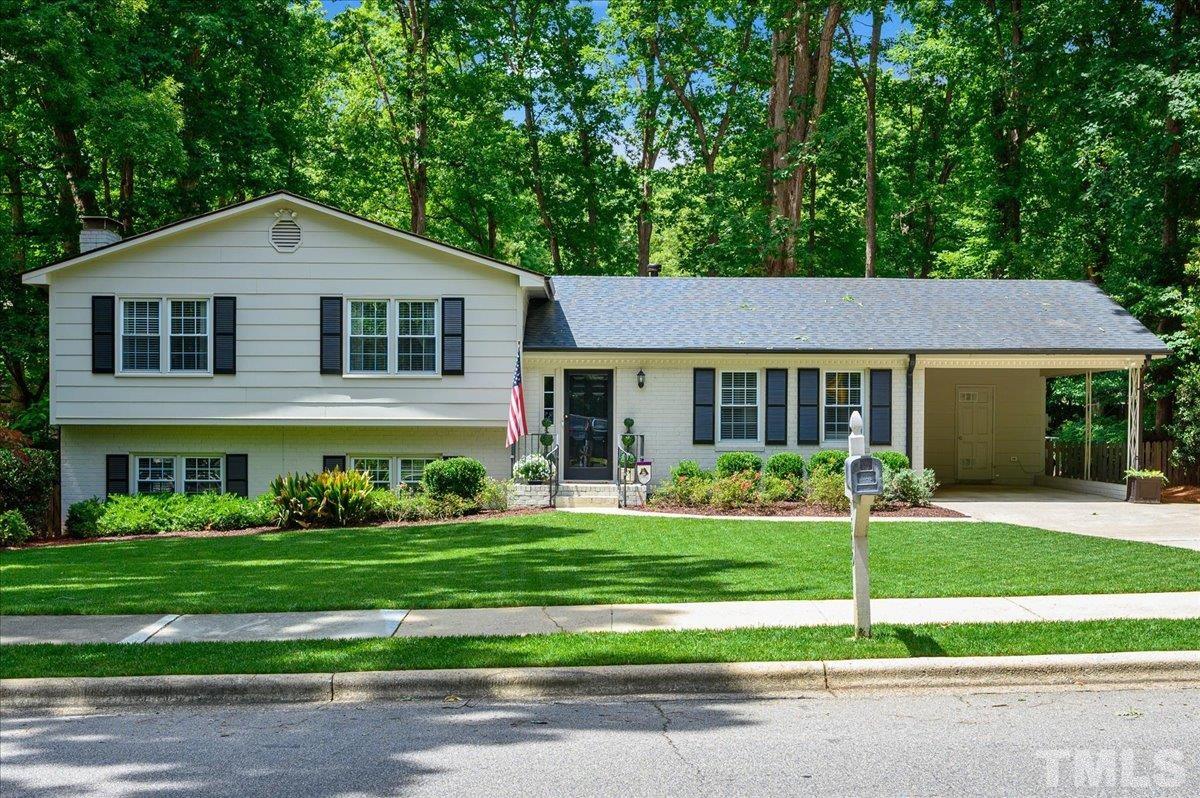 7509 Harps Mill Road Raleigh, NC 27615 - Photo 1 of 31 a front view of a house with a yard
