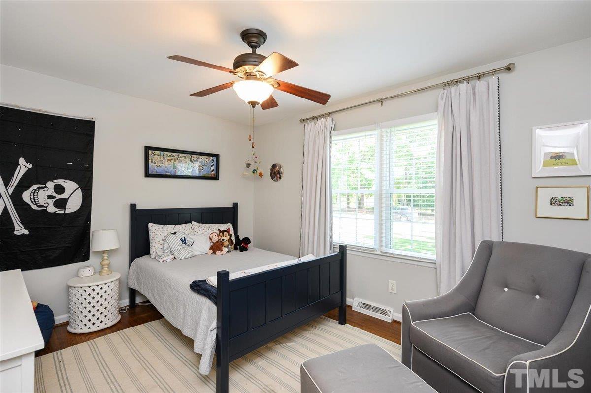 7509 Harps Mill Road Raleigh, NC 27615 - Photo 23 of 31 a bedroom with furniture and a window
