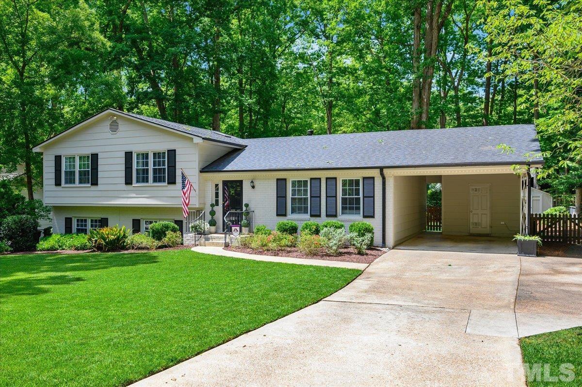 7509 Harps Mill Road Raleigh, NC 27615 - Photo 3 of 31 a front view of a house with a yard and porch