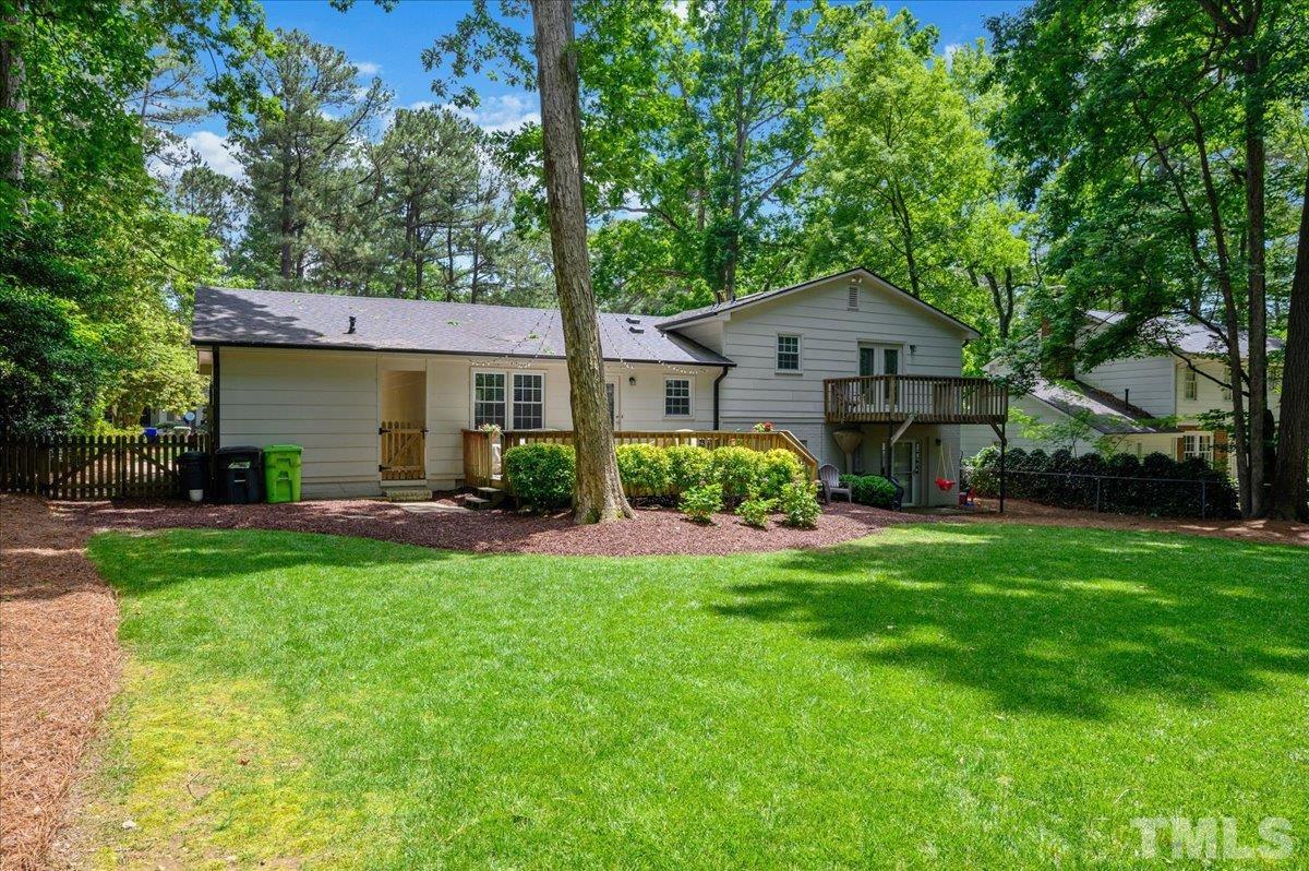 7509 Harps Mill Road Raleigh, NC 27615 - Photo 5 of 31 a front view of a house with a yard and green space