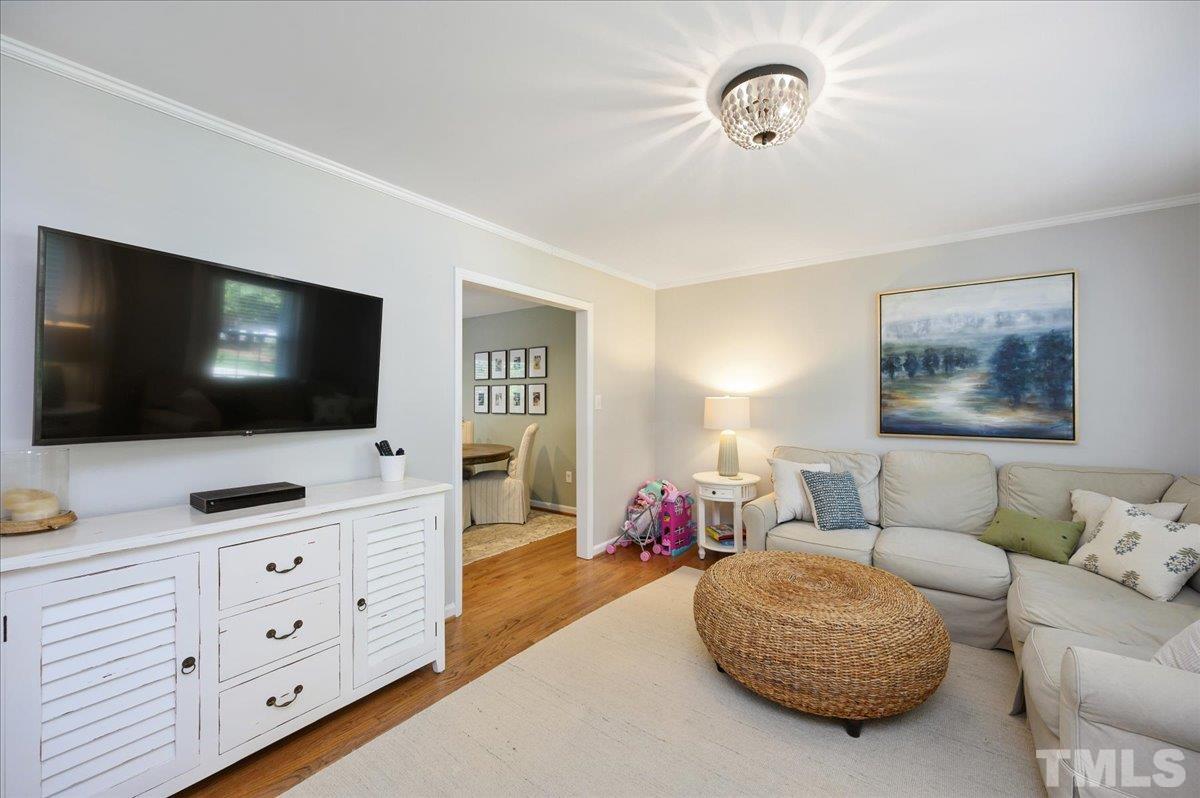 7509 Harps Mill Road Raleigh, NC 27615 - Photo 10 of 31 a living room with furniture and a flat screen tv