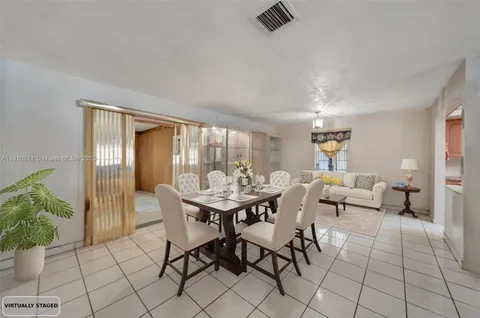 a dining room with furniture and wooden floor