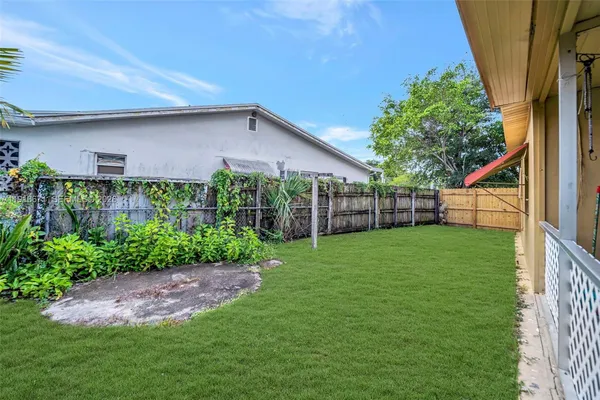 a view of a backyard with plants and a garden
