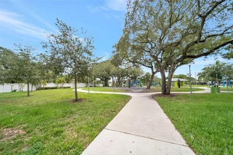 a huge green field with lots of trees