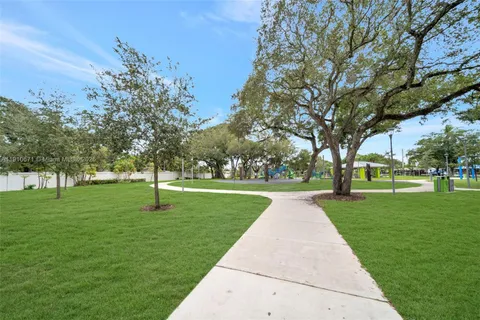 a huge green field with lots of trees