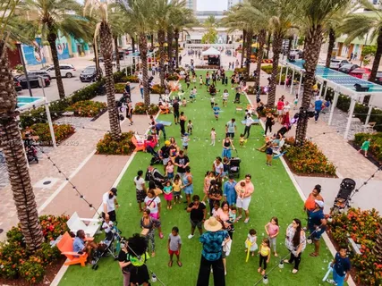 a view of a house with a yard and potted plants