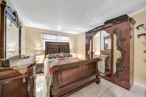 a bedroom with a bed and large windows