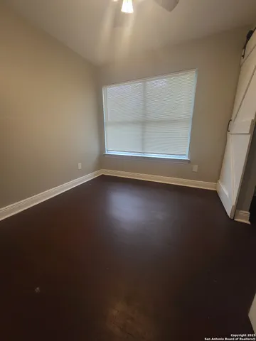 a view of room with window and hardwood floor