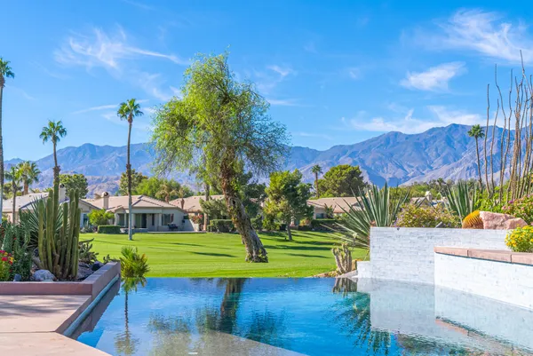 a view of a backyard with swimming pool