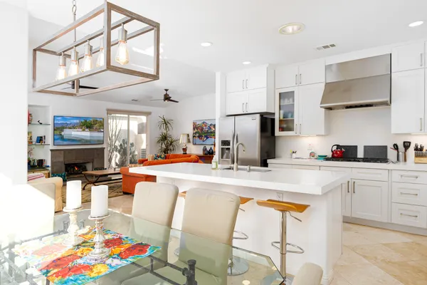 a kitchen with stainless steel appliances granite countertop a refrigerator and a stove top oven