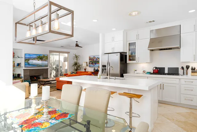 a kitchen with stainless steel appliances granite countertop a refrigerator and a stove top oven