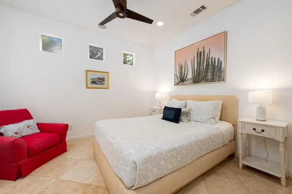 a bedroom with a bed and a couch