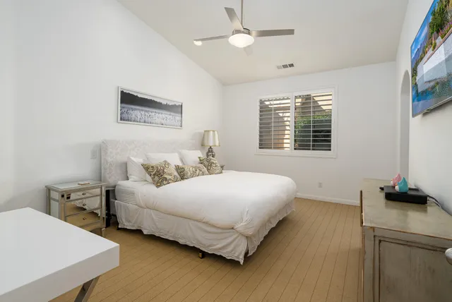 a bedroom with bed and a window