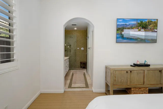 a living room with a baby crib furniture and a window