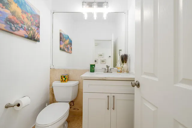 a bathroom with a sink a mirror and a toilet