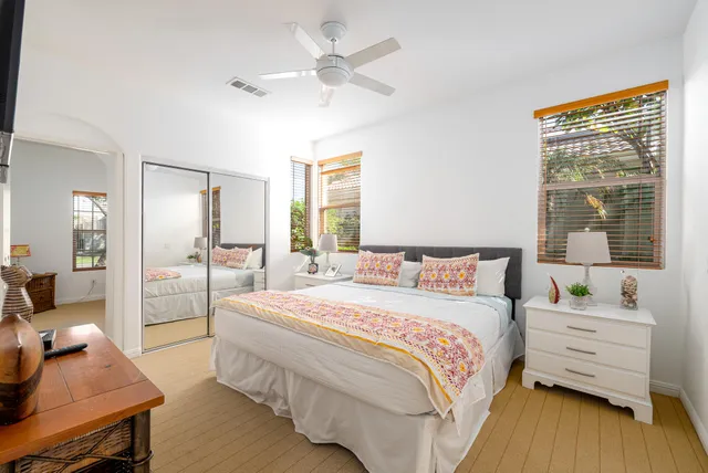 a bedroom with a bed and a desk