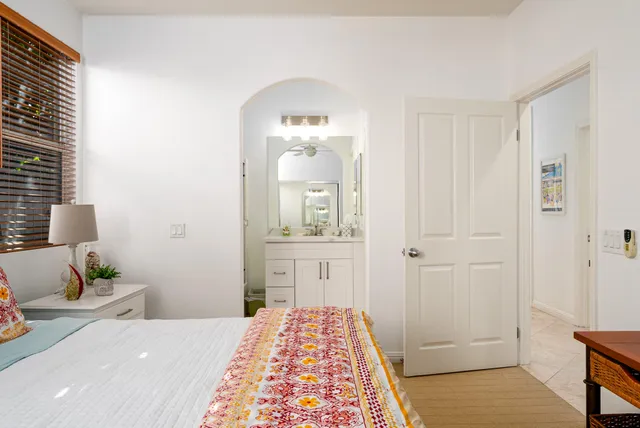 a bedroom with a bed and a mirror