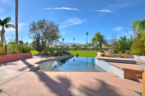 a view of a swimming pool and lounge chair