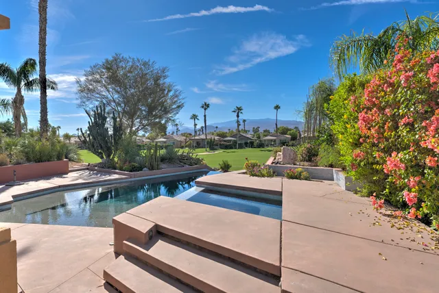 a view of a patio with couches table and chairs and potted plants