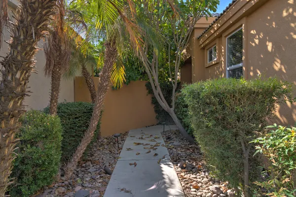 a view of a pathway both side of house