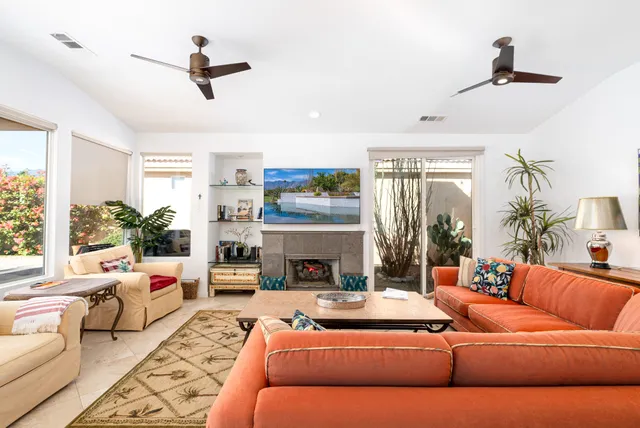 a living room with furniture and a fireplace