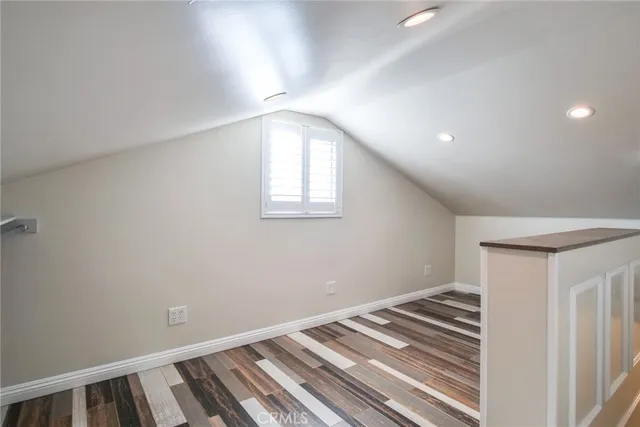 a view of a room with wooden floor and staircase