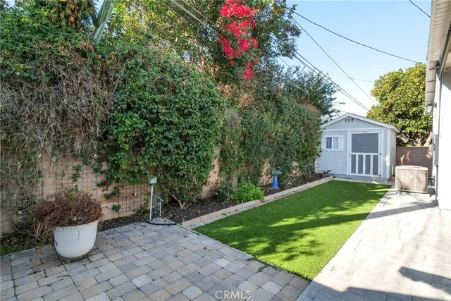 a view of a backyard with garden and plants