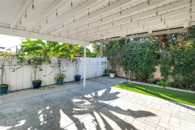 a backyard of a house with lots of green space and glass doors