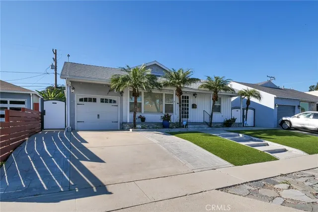 a front view of a house with a yard and a garage