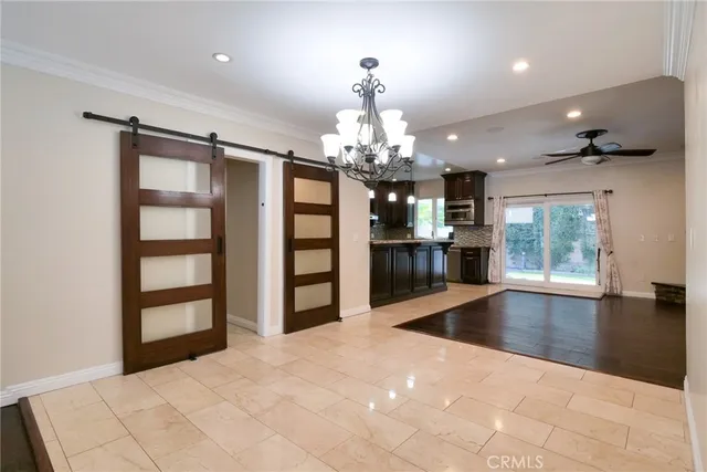 a view of a living room kitchen and a chandelier