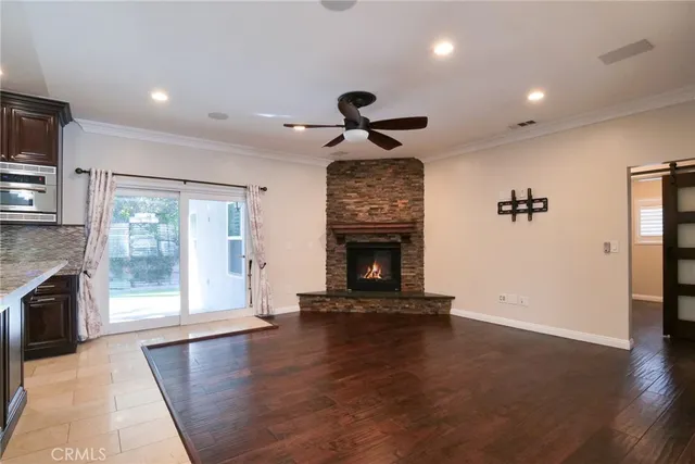 a view of an empty room with a fireplace and a window