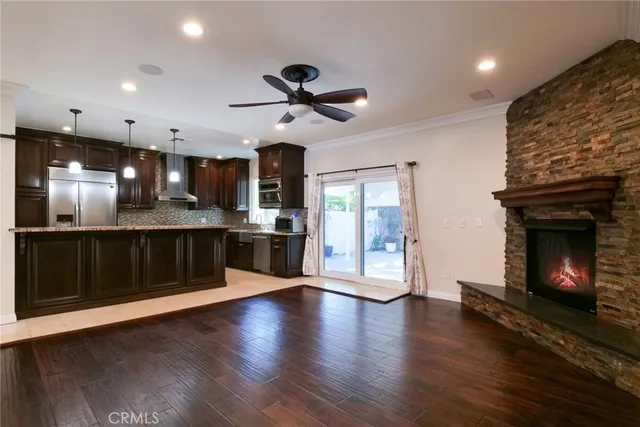 a view of a kitchen with a sink and a fireplace