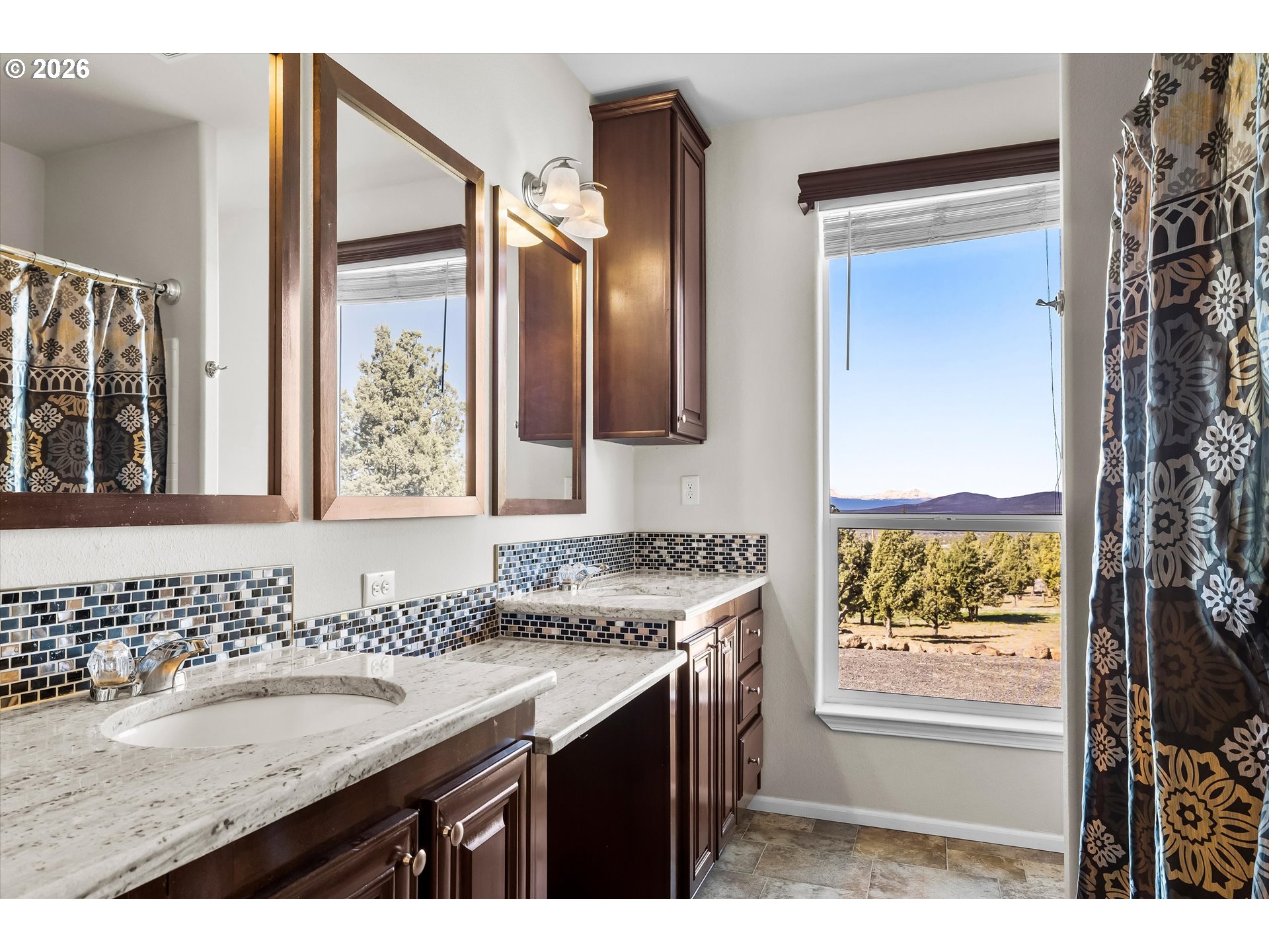 5172 Southeast Oswego Road Prineville, OR 97754 - Photo 18 of 48 a bathroom with a granite countertop sink a mirror and a bathtub