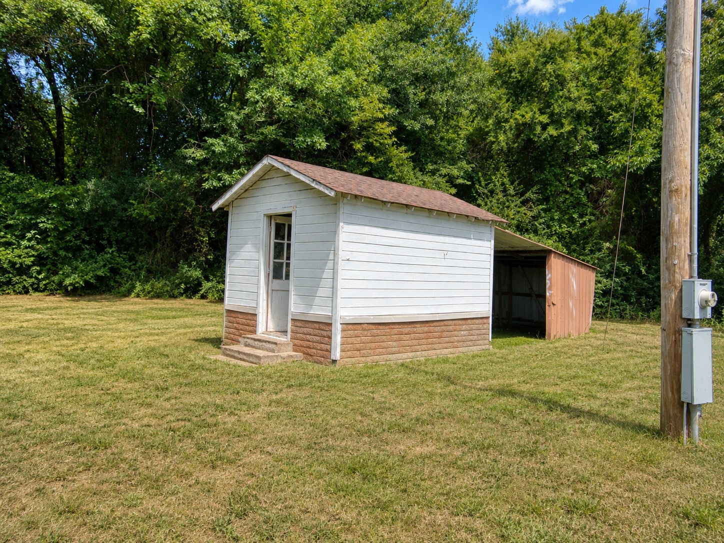 461924 East 1140 Road Sallisaw, OK 74955 - Photo 26 of 29 White siding exterior with a brown shingle roof
