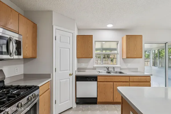 a bathroom with a sink double vanity granite tub shower and a mirror