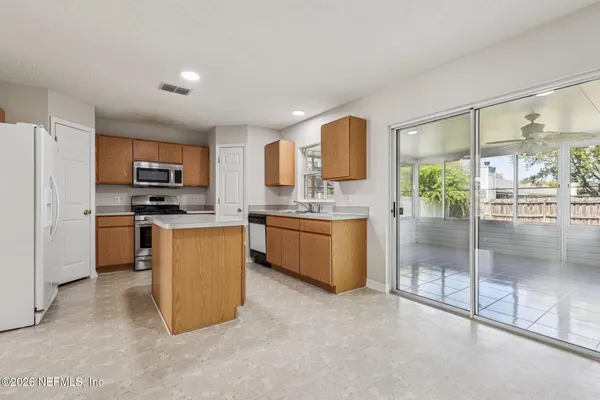 an empty room with a bathroom and a window