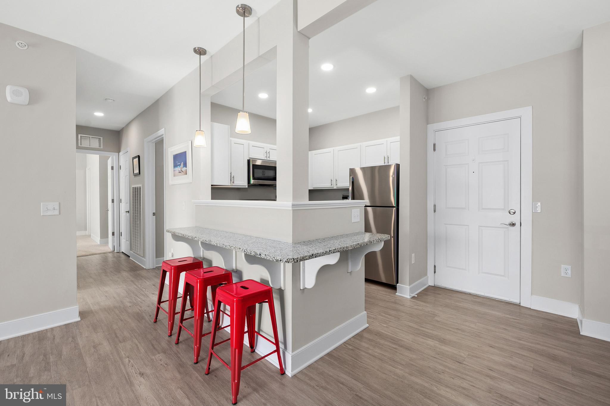 30609 Cedar Neck Road, Unit 3108 Ocean View, DE 19970 - Photo 12 of 42 a kitchen with stainless steel appliances a refrigerator and a stove