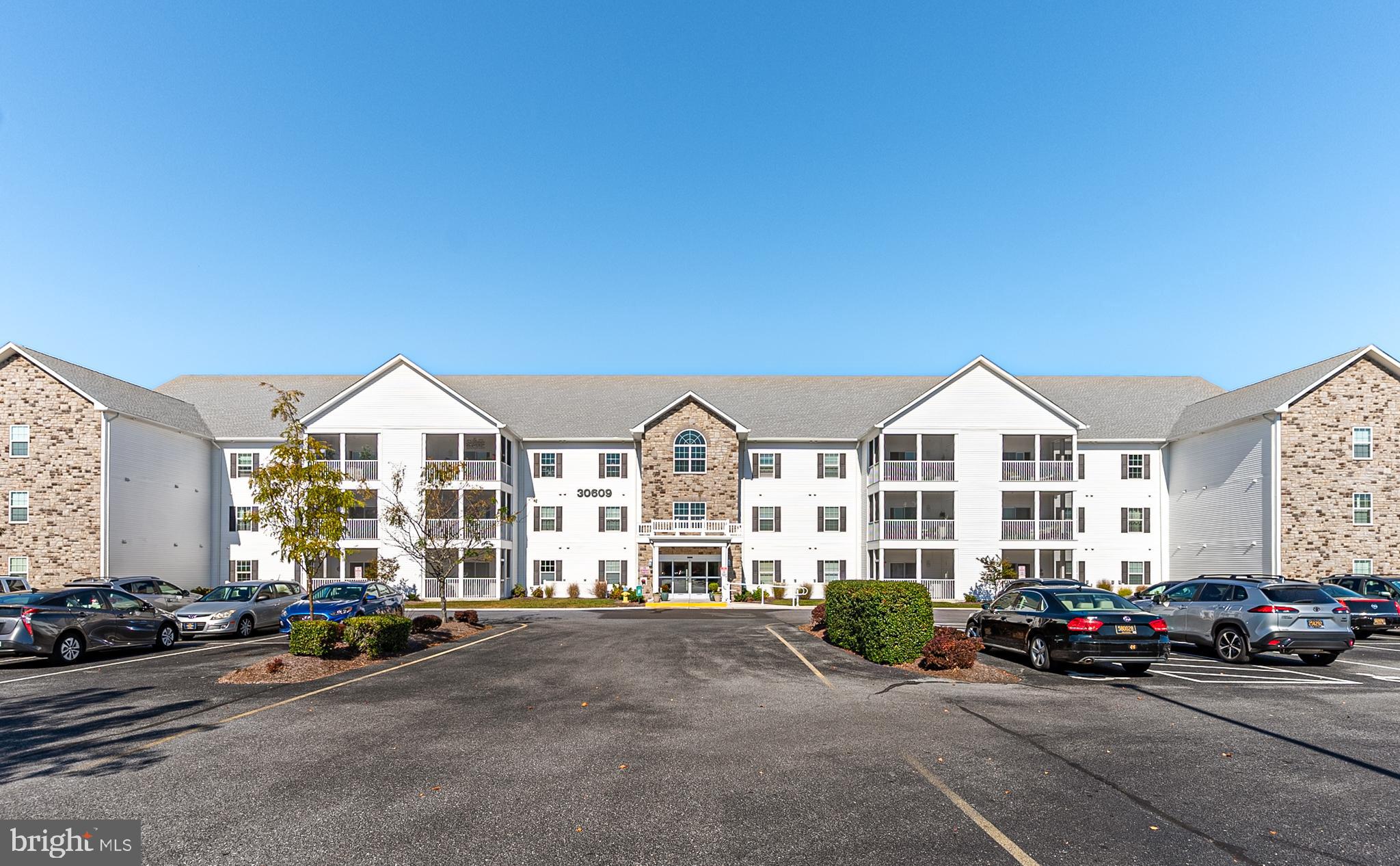 30609 Cedar Neck Road, Unit 3108 Ocean View, DE 19970 - Photo 2 of 42 a view of a parked cars in front of a house