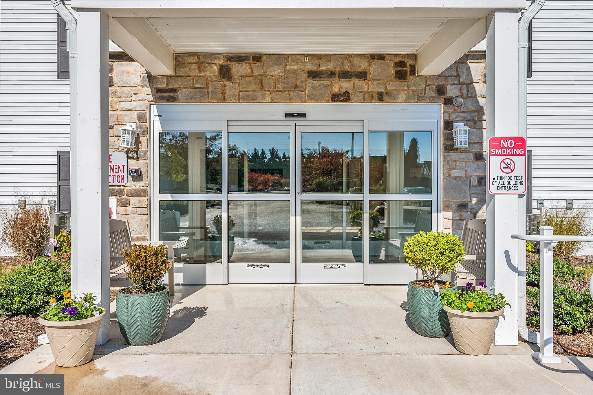 30609 Cedar Neck Road, Unit 3108 Ocean View, DE 19970 - Photo 34 of 42 a view of a building with potted plants