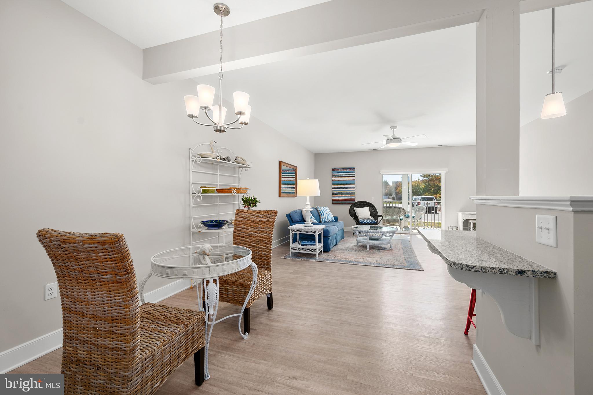 30609 Cedar Neck Road, Unit 3108 Ocean View, DE 19970 - Photo 42 of 42 a living room with furniture a chandelier and a dining table