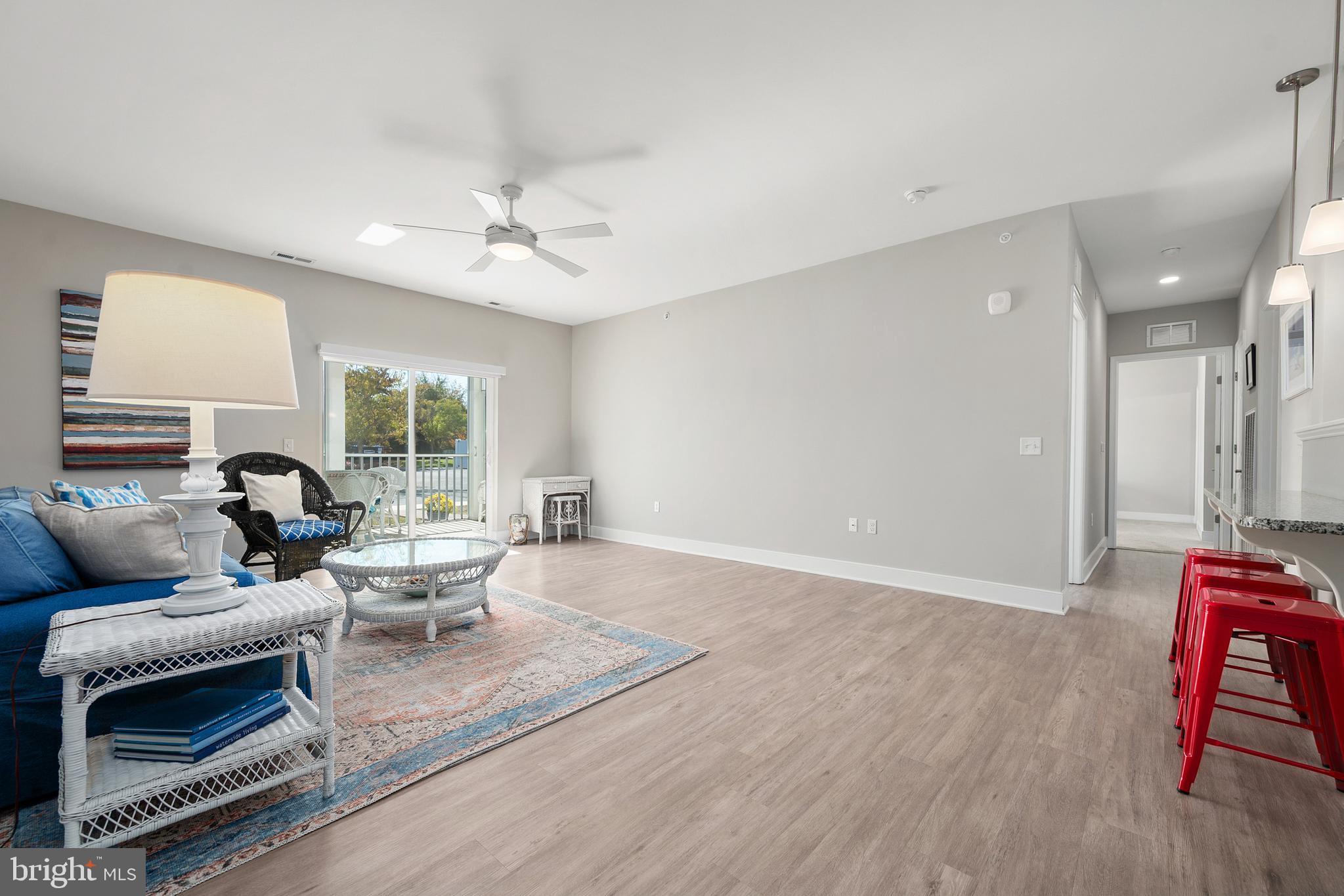 30609 Cedar Neck Road, Unit 3108 Ocean View, DE 19970 - Photo 5 of 42 a living room with furniture and a floor to ceiling window