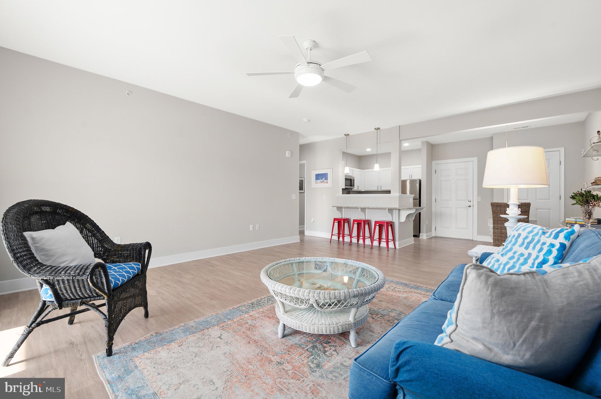30609 Cedar Neck Road, Unit 3108 Ocean View, DE 19970 - Photo 9 of 42 a living room with furniture and a chandelier