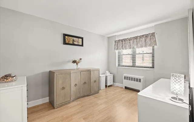 a view of a room with wooden floor and cabinet