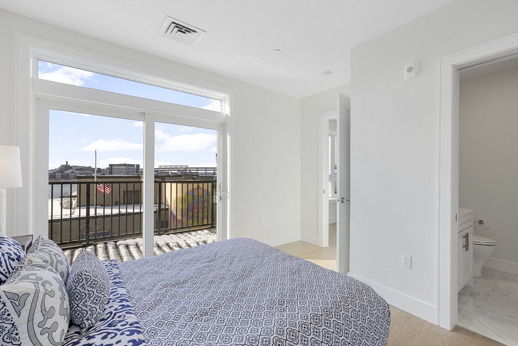 301 Border Street, Unit 611 Boston, MA 02128 - Photo 13 of 32 a bedroom with a bed and a large window