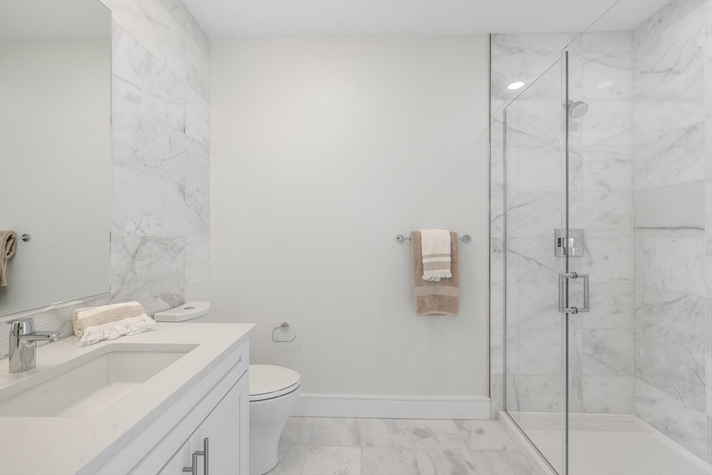 301 Border Street, Unit 611 Boston, MA 02128 - Photo 14 of 32 a bathroom with a sink a toilet and shower